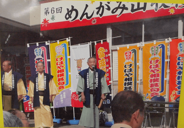 写真3：島根県飯南町の「野見宿禰赤名相撲甚句会」の人達と交流を行う様子を表す写真。伝統文化の継承だけではなく、相撲甚句会を通じ自治体間の交流の活性化につながる。